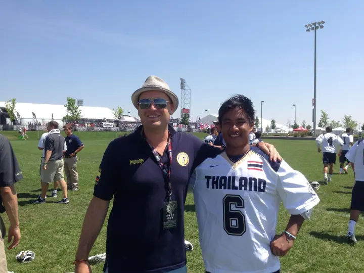 Two men smiling together on a tournament field.